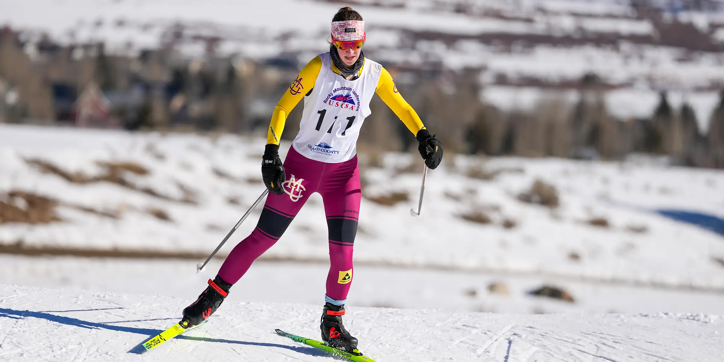 CMU cross country skier racing on a snowy course