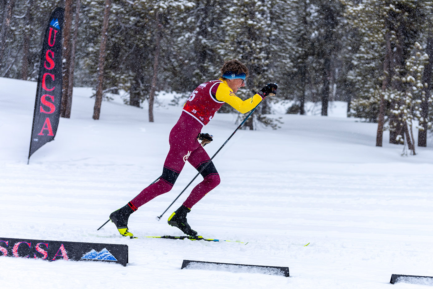 CMU skier striding in the classic technique during a USCSA race, demonstrating efficient body position and pole angle—core elements discussed in choosing optimal ski and pole lengths.