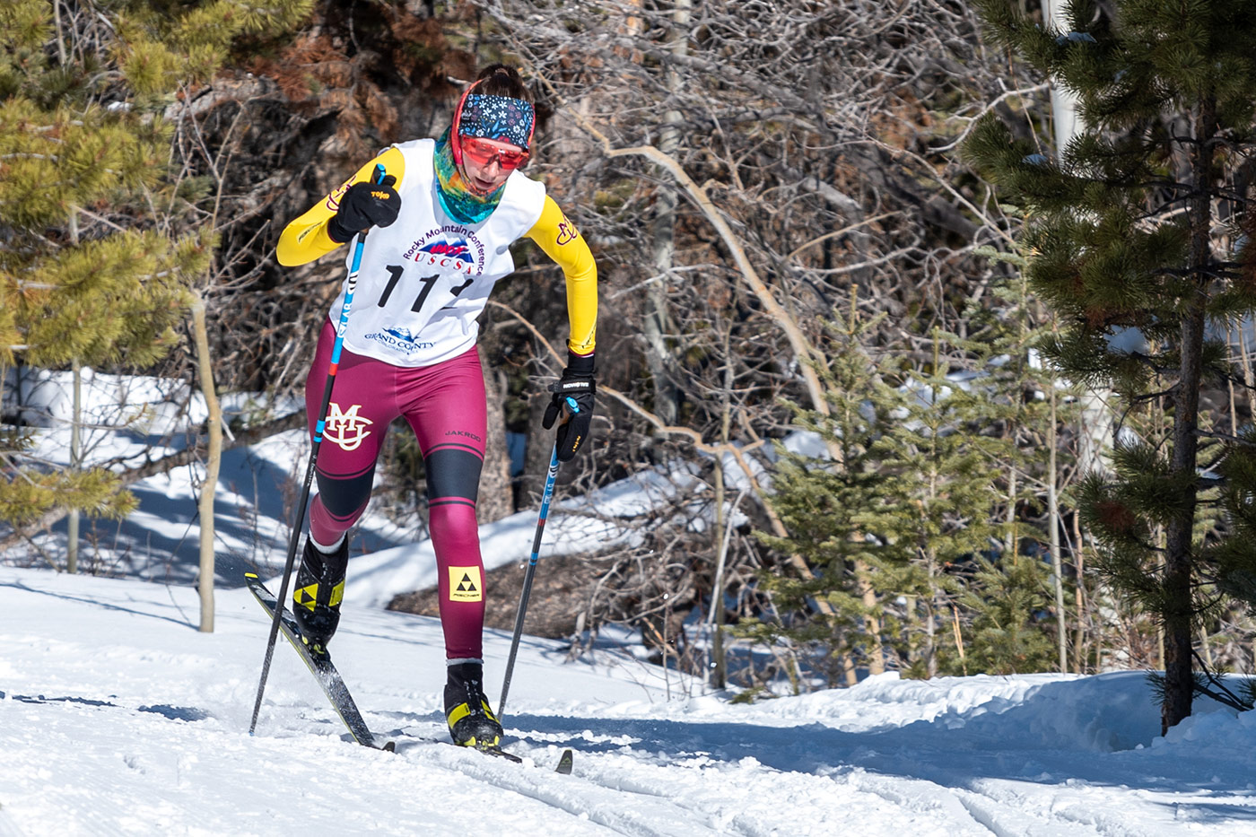 CMU cross country skier racing in the classic technique at a USCSA event, illustrating effective weight transfer and pole use in the context of optimal ski and pole length selection.